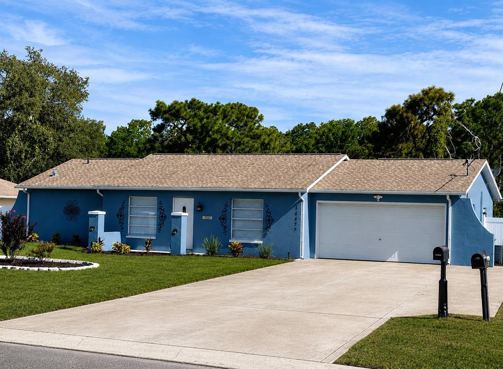 11177 Elgin Boulevard Spring Hill, FL 34608 - Photo 1 of 10 a front view of a house with a yard