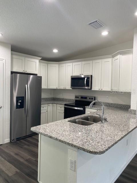 40 Maple Lane Ocklawaha, FL 32179 - Photo 21 of 50 a kitchen with kitchen island granite countertop a sink a center island stainless steel appliances and cabinets