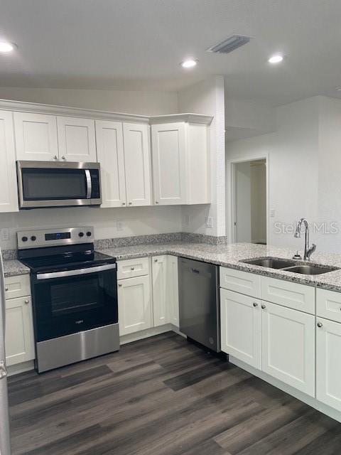 40 Maple Lane Ocklawaha, FL 32179 - Photo 26 of 50 a kitchen with granite countertop a stove a sink and a microwave