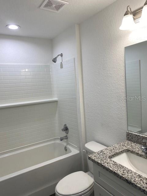 40 Maple Lane Ocklawaha, FL 32179 - Photo 34 of 50 a bathroom with a granite countertop toilet a sink and bathtub