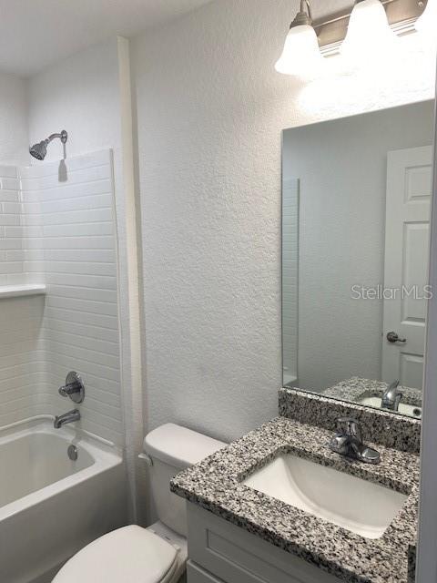 40 Maple Lane Ocklawaha, FL 32179 - Photo 35 of 50 a bathroom with a granite countertop sink a toilet and bathtub