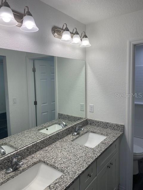 40 Maple Lane Ocklawaha, FL 32179 - Photo 8 of 50 a bathroom with a granite countertop sink and a mirror