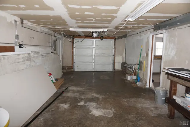 a view of backyard with wooden fence and trees