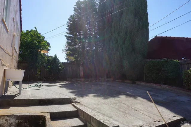 a view of a backyard with sitting area
