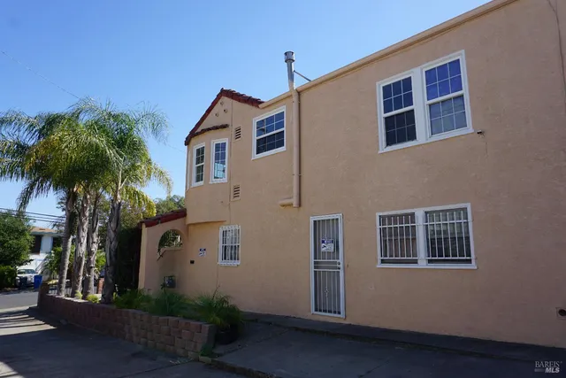 a view of a house with wooden fence