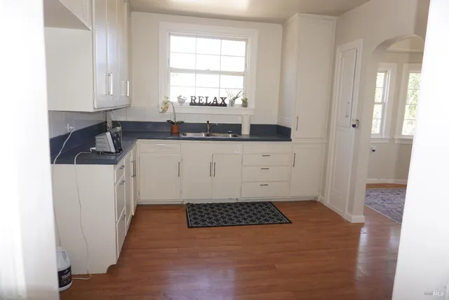 a bathroom with a sink a window and a mirror