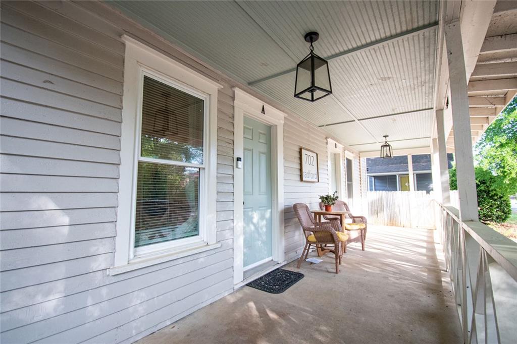 702 Radford Street Monroe, GA 30655 - Photo 4 of 49 a view of a porch with furniture and floor to ceiling window