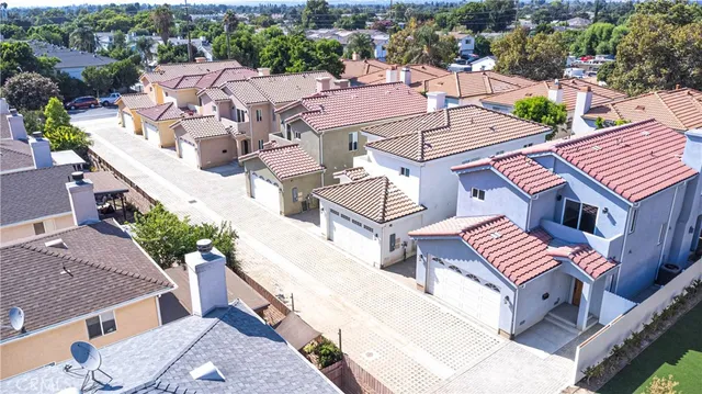 an aerial view of a house with a yard and mountain view in back