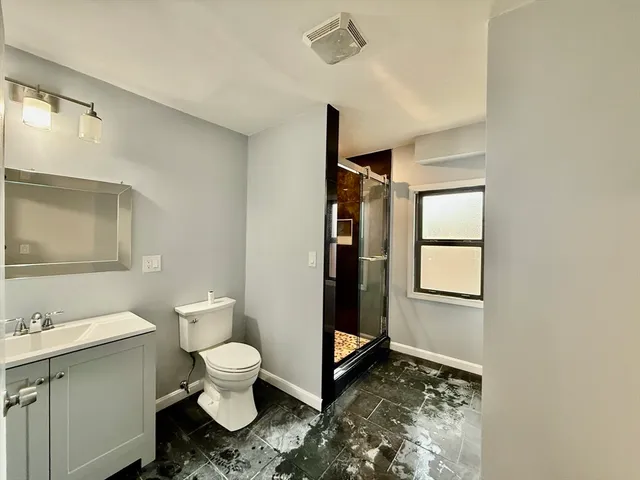 a bathroom with a toilet sink and a mirror