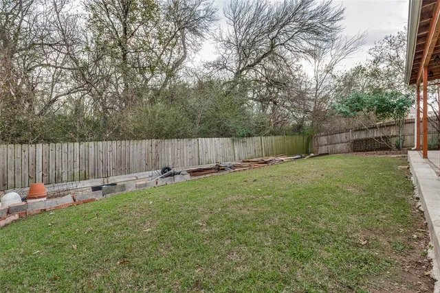 a view of a house with a yard and sitting area