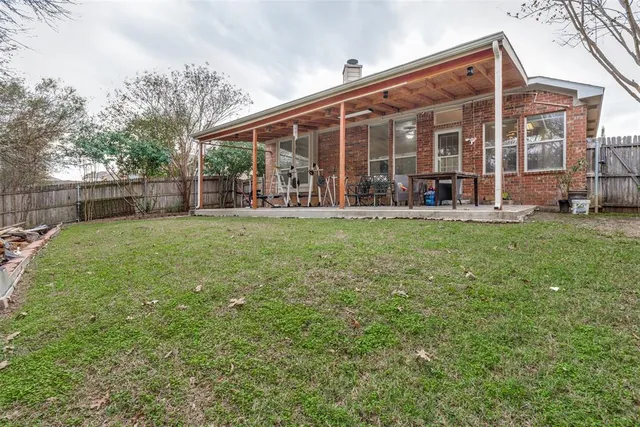 a view of a house with yard and sitting area