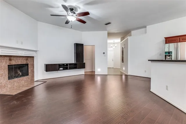 a view of an empty room with a fireplace and a window