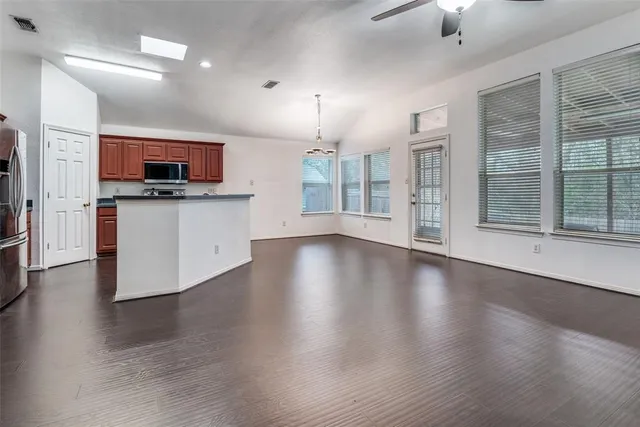 an open kitchen with sink and microwave