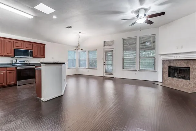 a view of a kitchen with a sink a refrigerator and a stove top oven