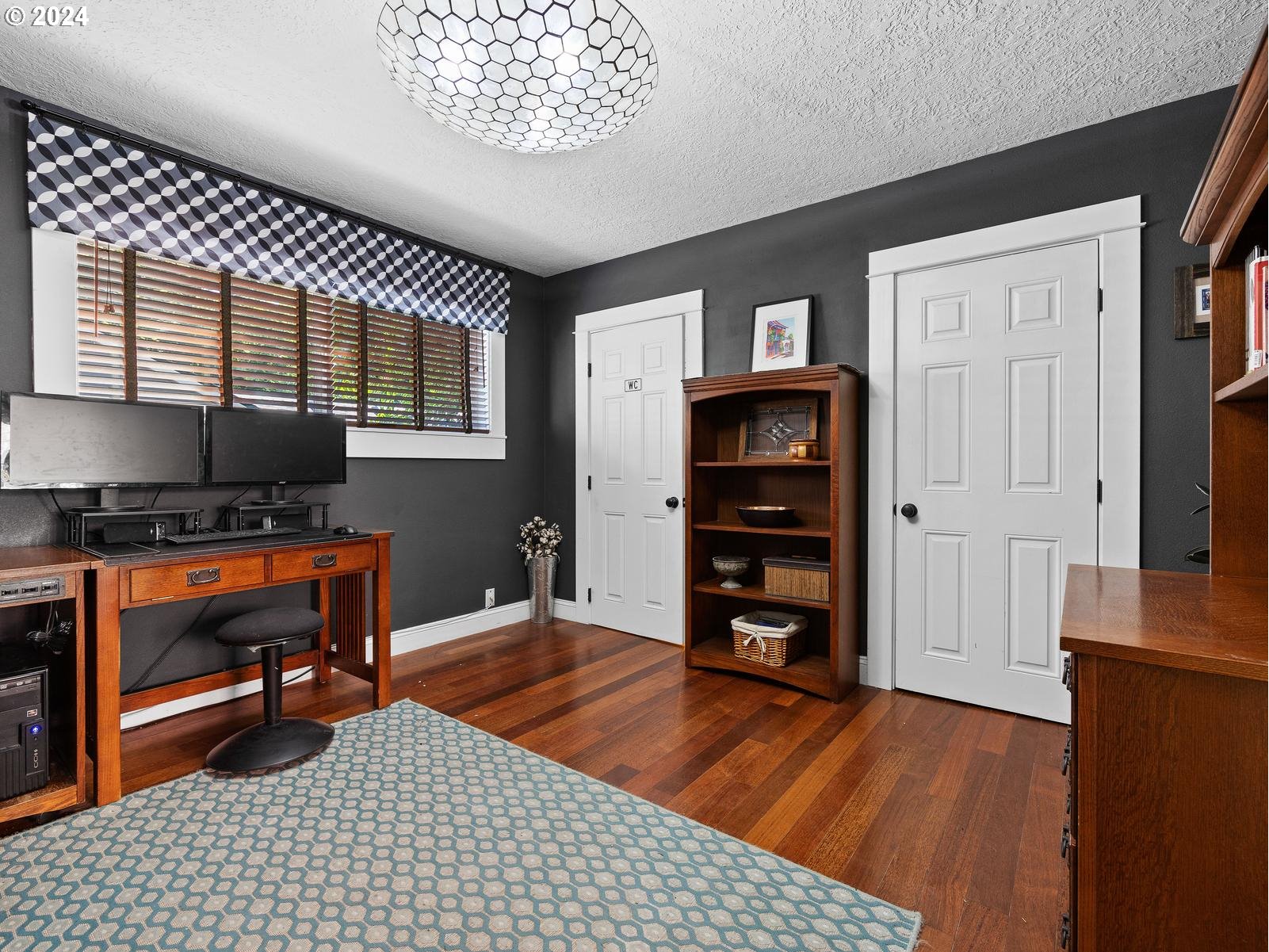 2306 Northeast Couch Street Portland, OR 97232 - Photo 19 of 48 a room with furniture a flat screen tv and a dresser