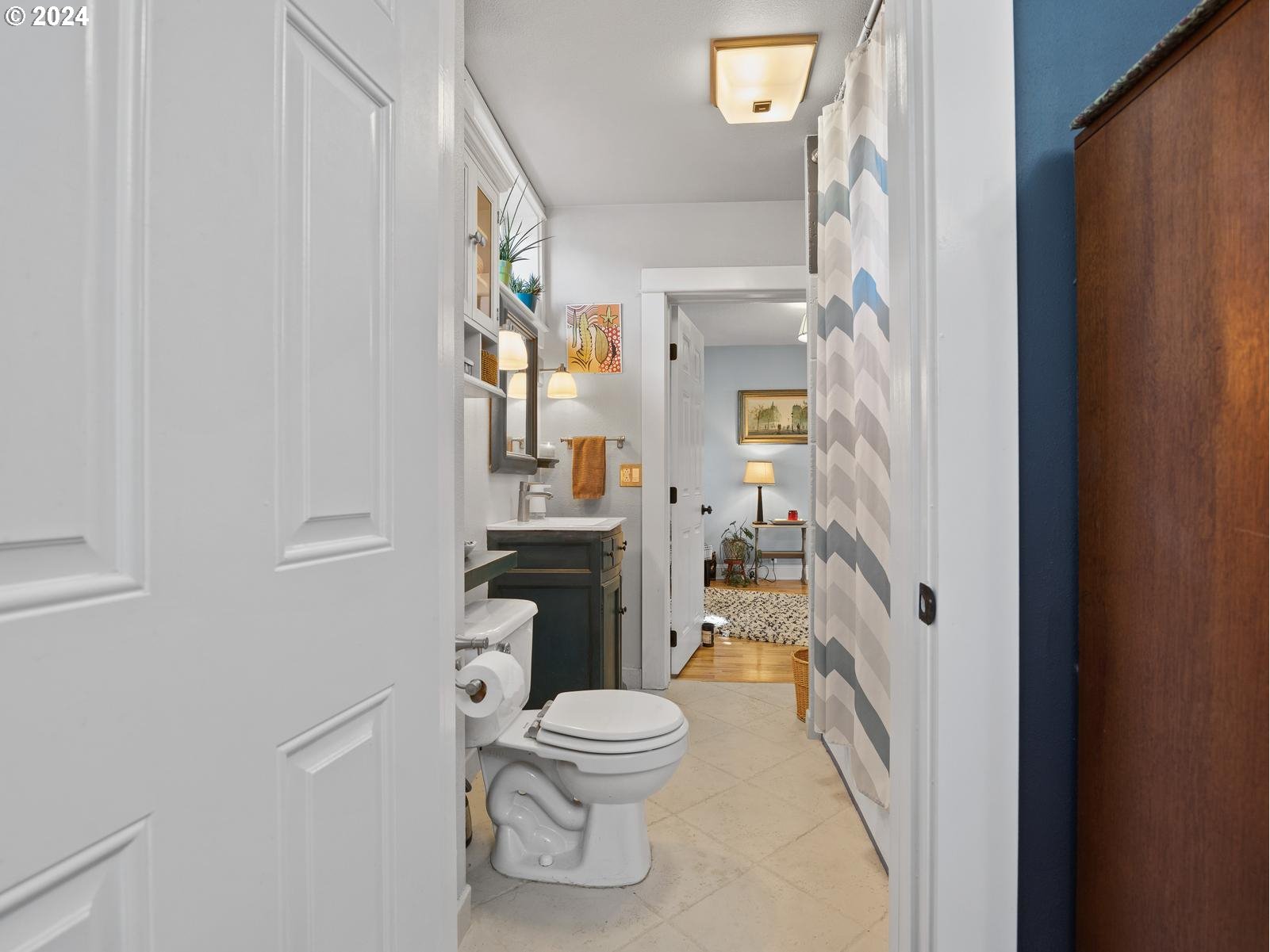 2306 Northeast Couch Street Portland, OR 97232 - Photo 20 of 48 a bathroom with a toilet a sink and a shower