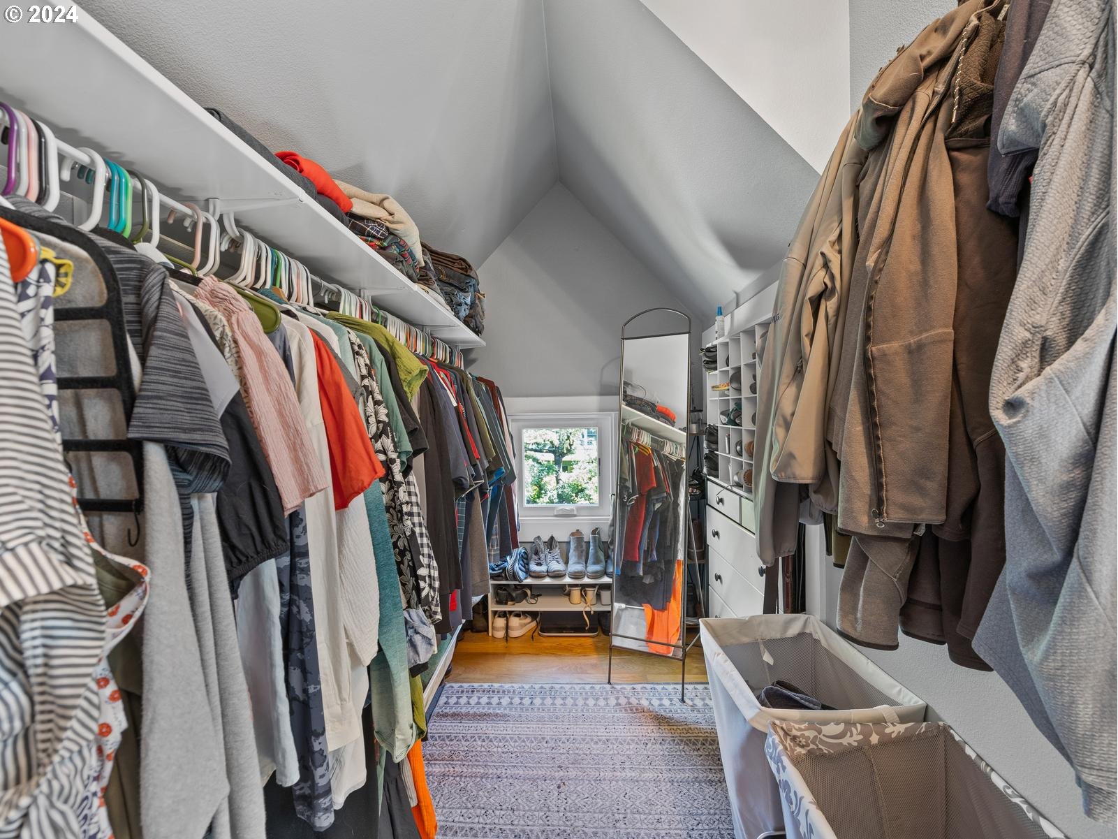 2306 Northeast Couch Street Portland, OR 97232 - Photo 27 of 48 a view of walk in closet with clothes and shoes