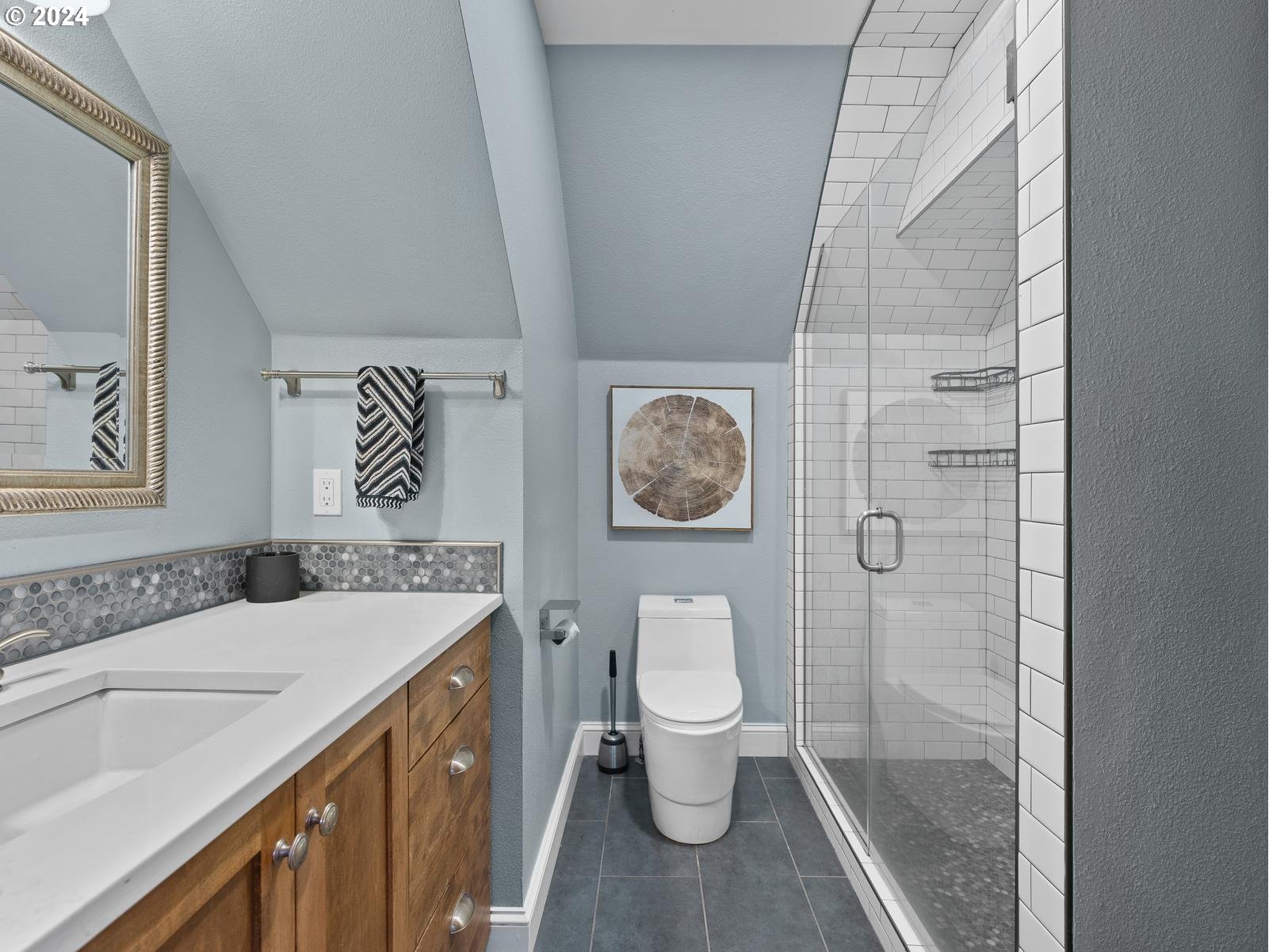 2306 Northeast Couch Street Portland, OR 97232 - Photo 32 of 48 a bathroom with a sink a toilet and shower