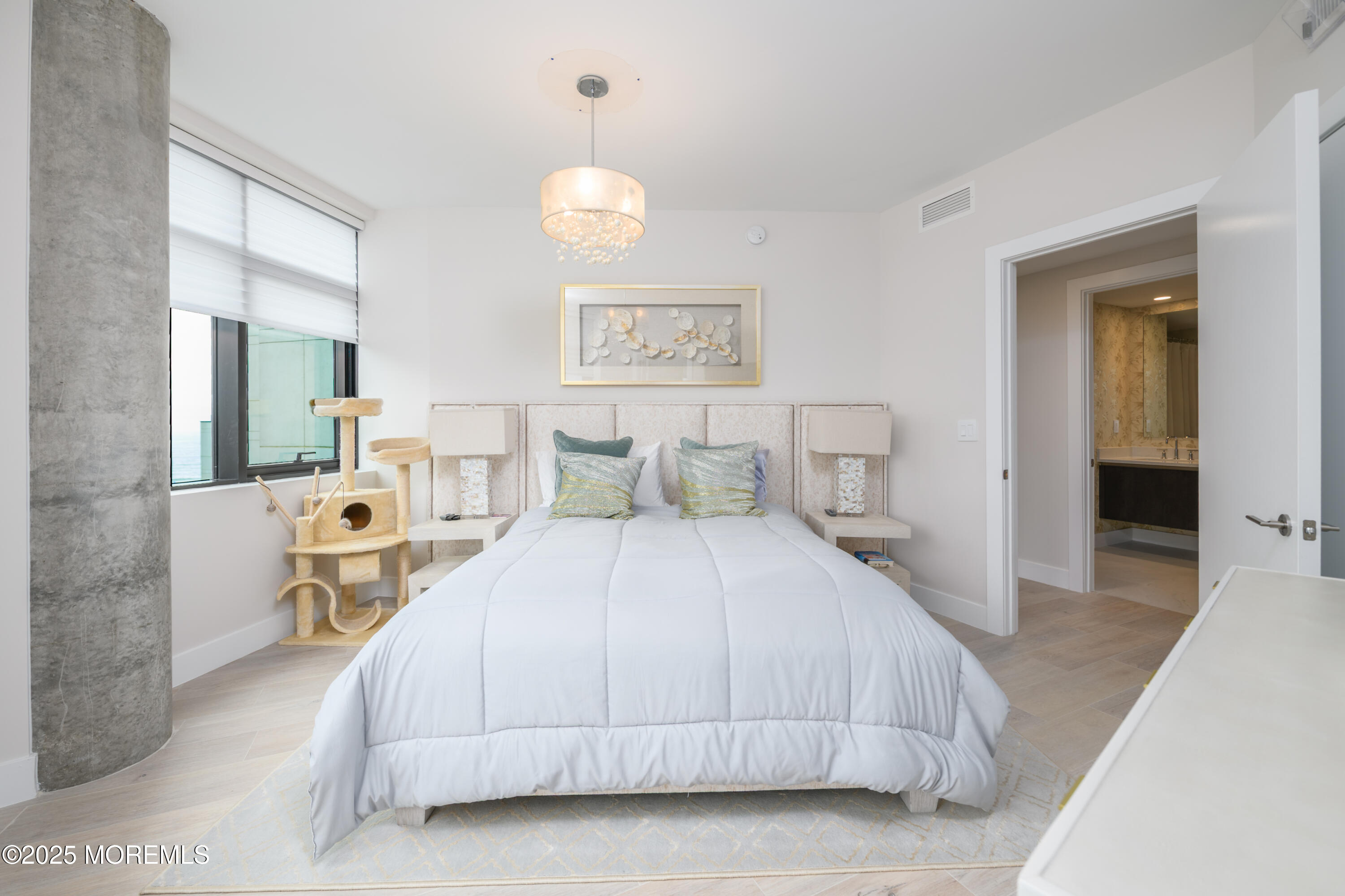 350 Ocean Avenue, Unit 403 Long Branch, NJ 07740 - Photo 15 of 23 a bedroom with a large bed and a chandelier