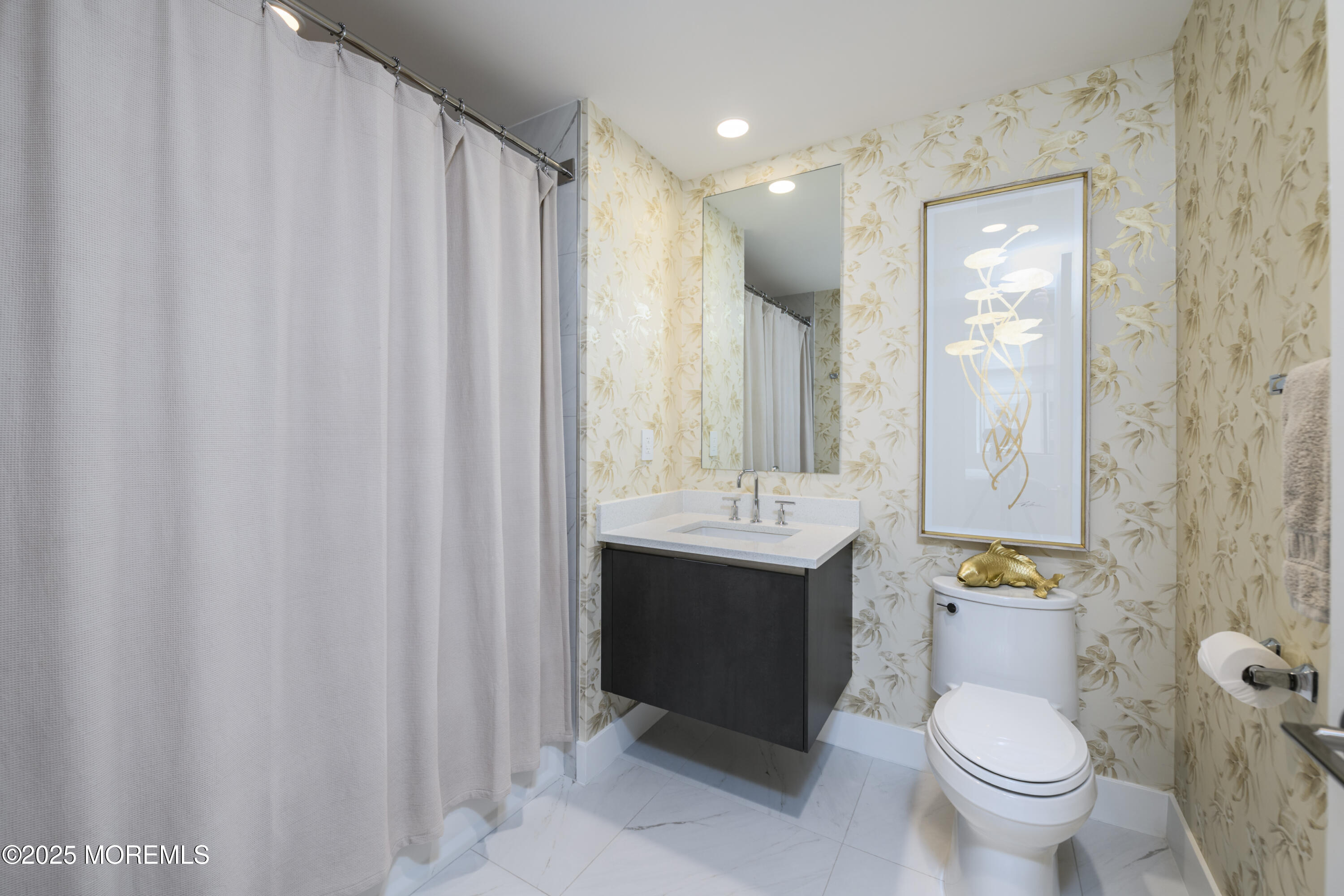 350 Ocean Avenue, Unit 403 Long Branch, NJ 07740 - Photo 16 of 23 a bathroom with a sink a toilet and shower