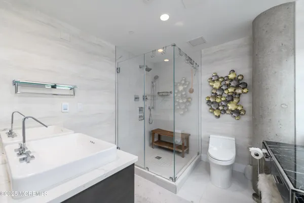 a bathroom with a sink toilet and shower