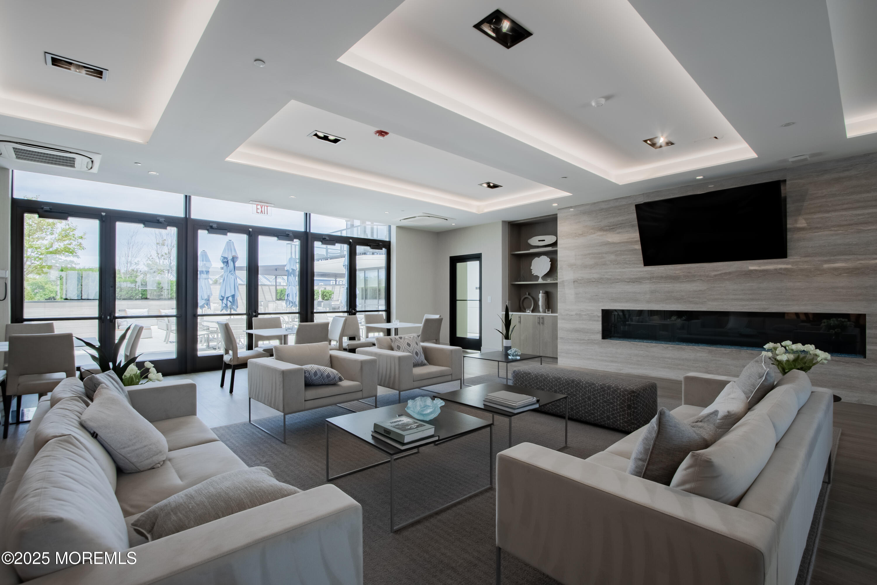 350 Ocean Avenue, Unit 403 Long Branch, NJ 07740 - Photo 4 of 23 a living room with furniture and a flat screen tv