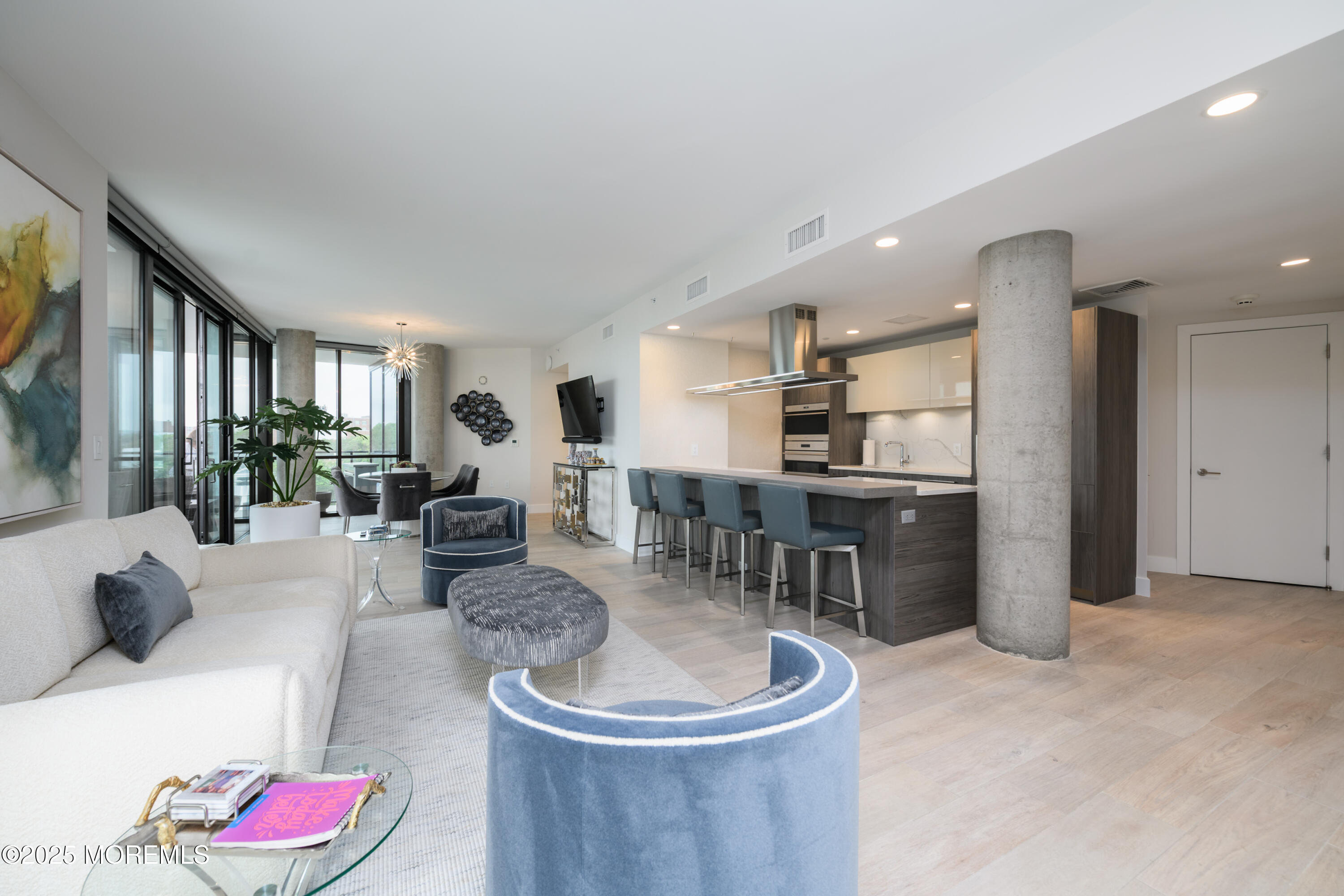 350 Ocean Avenue, Unit 403 Long Branch, NJ 07740 - Photo 8 of 23 a living room with furniture and a dining table with kitchen view