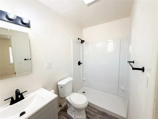 a white toilet sitting next to a bathroom sink