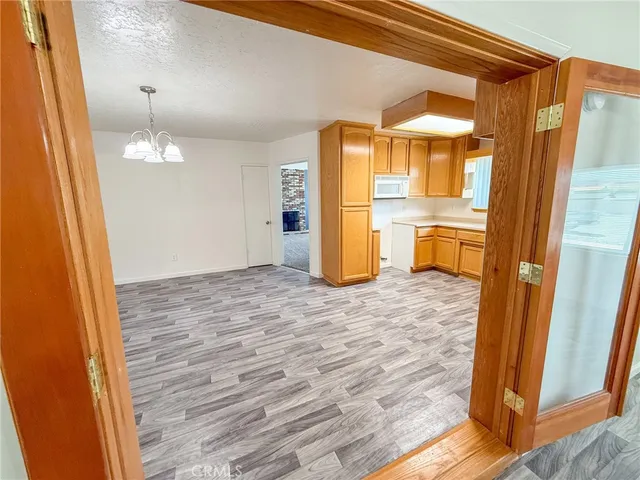 a view of a room with wooden floor and chair