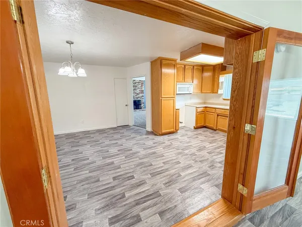 a view of a room with wooden floor and chair