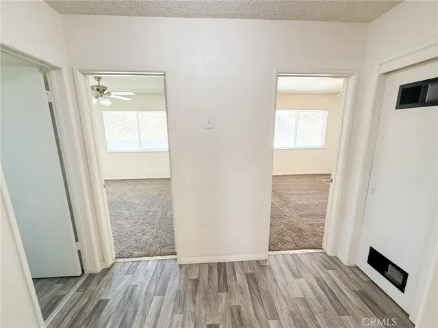 a view of a room with wooden floor and windows