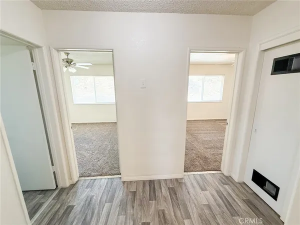 a view of a room with wooden floor and windows
