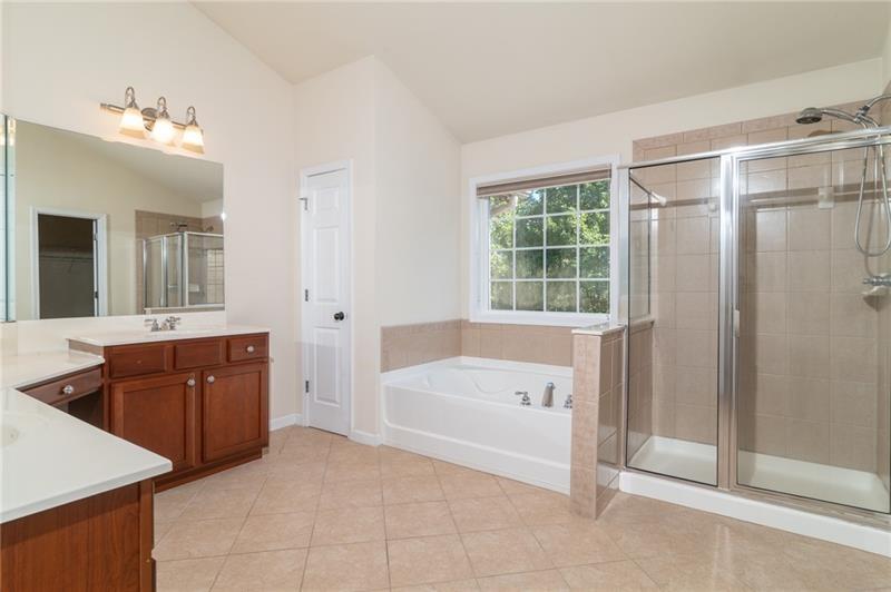 206 Sawtooth Court Canton, GA 30114 - Photo 19 of 42 a spacious bathroom with a tub sink and mirror