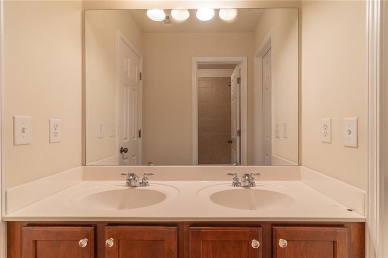 206 Sawtooth Court Canton, GA 30114 - Photo 25 of 42 a bathroom with double sink and a mirror