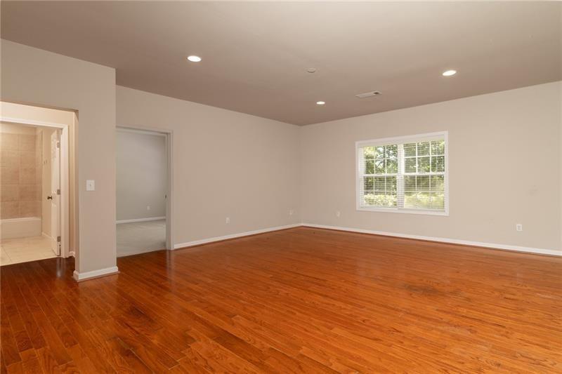 206 Sawtooth Court Canton, GA 30114 - Photo 28 of 42 an empty room with wooden floor and windows