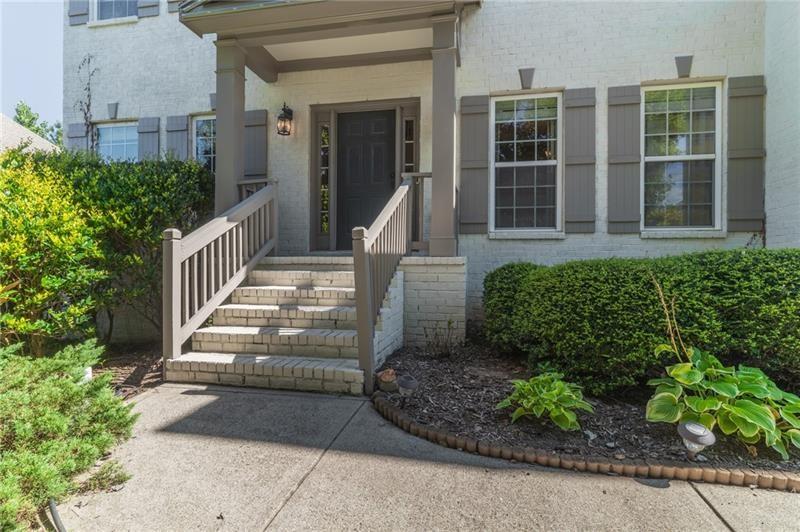 206 Sawtooth Court Canton, GA 30114 - Photo 6 of 42 a front view of a house with a garden