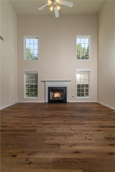 206 Sawtooth Court Canton, GA 30114 - Photo 8 of 42 a view of an empty room with wooden floor and a window