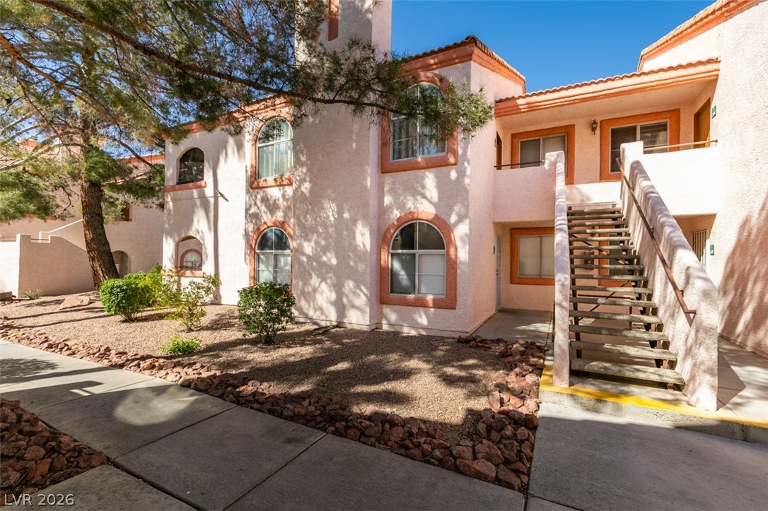 7570 West Flamingo Road, Unit 252 Las Vegas, NV 89147 - Photo 3 of 44 A terracotta-tiled roofline crowns this building, showcasing arched windows and an inviting exterior stairway.