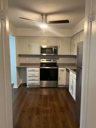 a kitchen with a stove and a refrigerator