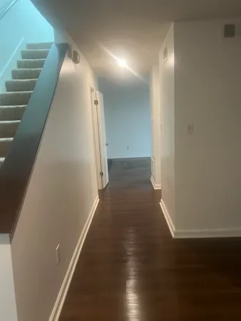 a view of a hallway with wooden floor