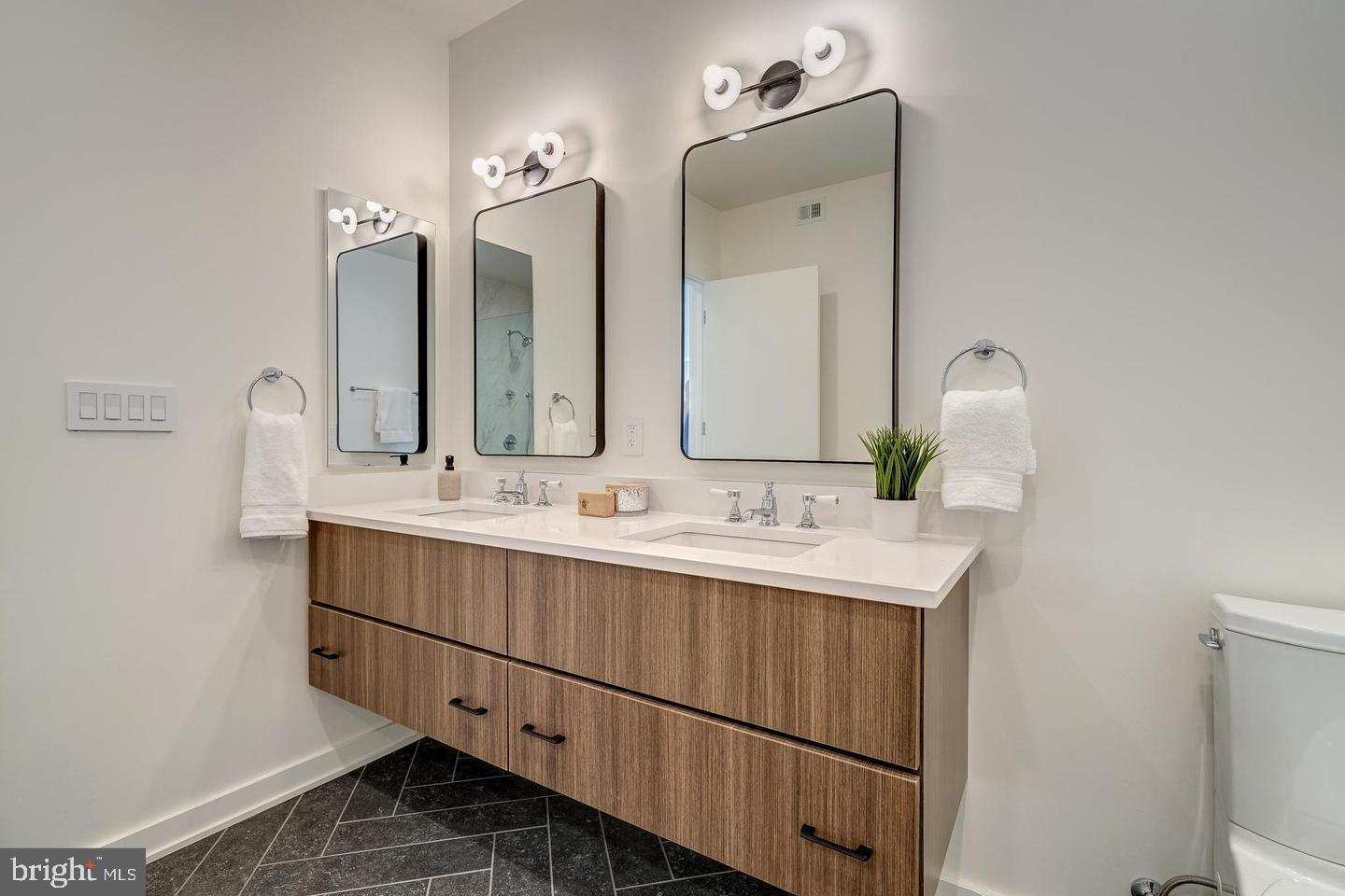 440 R Street Northwest, Unit 203 Washington, DC 20001 - Photo 24 of 32 a bathroom with a double vanity sink and a mirror