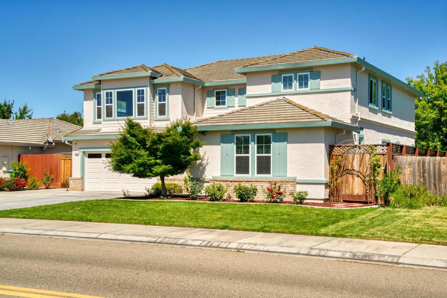 426 South Highland Avenue Ripon, CA 95366 - Photo 5 of 82 a front view of a house with a yard