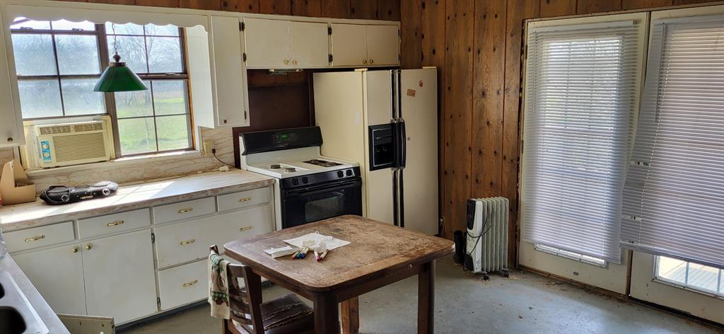 2846 County Road 2415 Como, TX 75431 - Photo 15 of 17 a kitchen with stainless steel appliances a stove refrigerator sink and cabinets