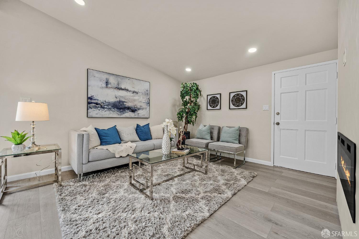 2625 Kavanagh Road San Pablo, CA 94806 - Photo 14 of 45 a living room with furniture wooden floor and a painting on the wall