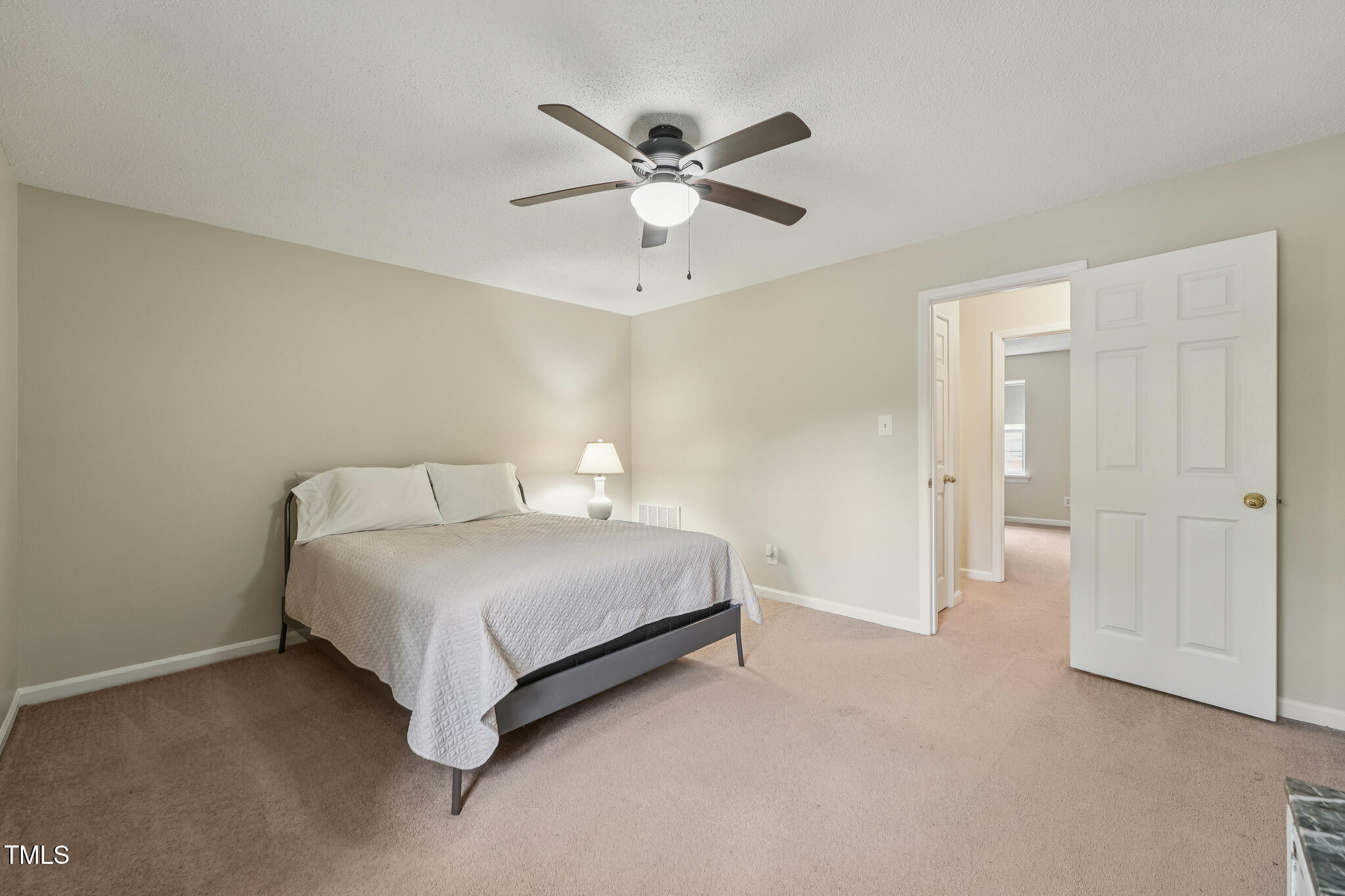 149 Jones Franklin Road, Unit A Raleigh, NC 27606 - Photo 11 of 21 a spacious bedroom with a bed and a ceiling fan