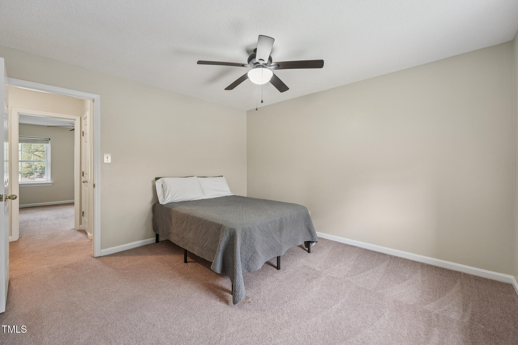 149 Jones Franklin Road, Unit A Raleigh, NC 27606 - Photo 12 of 21 a bedroom with a bed and ceiling fan