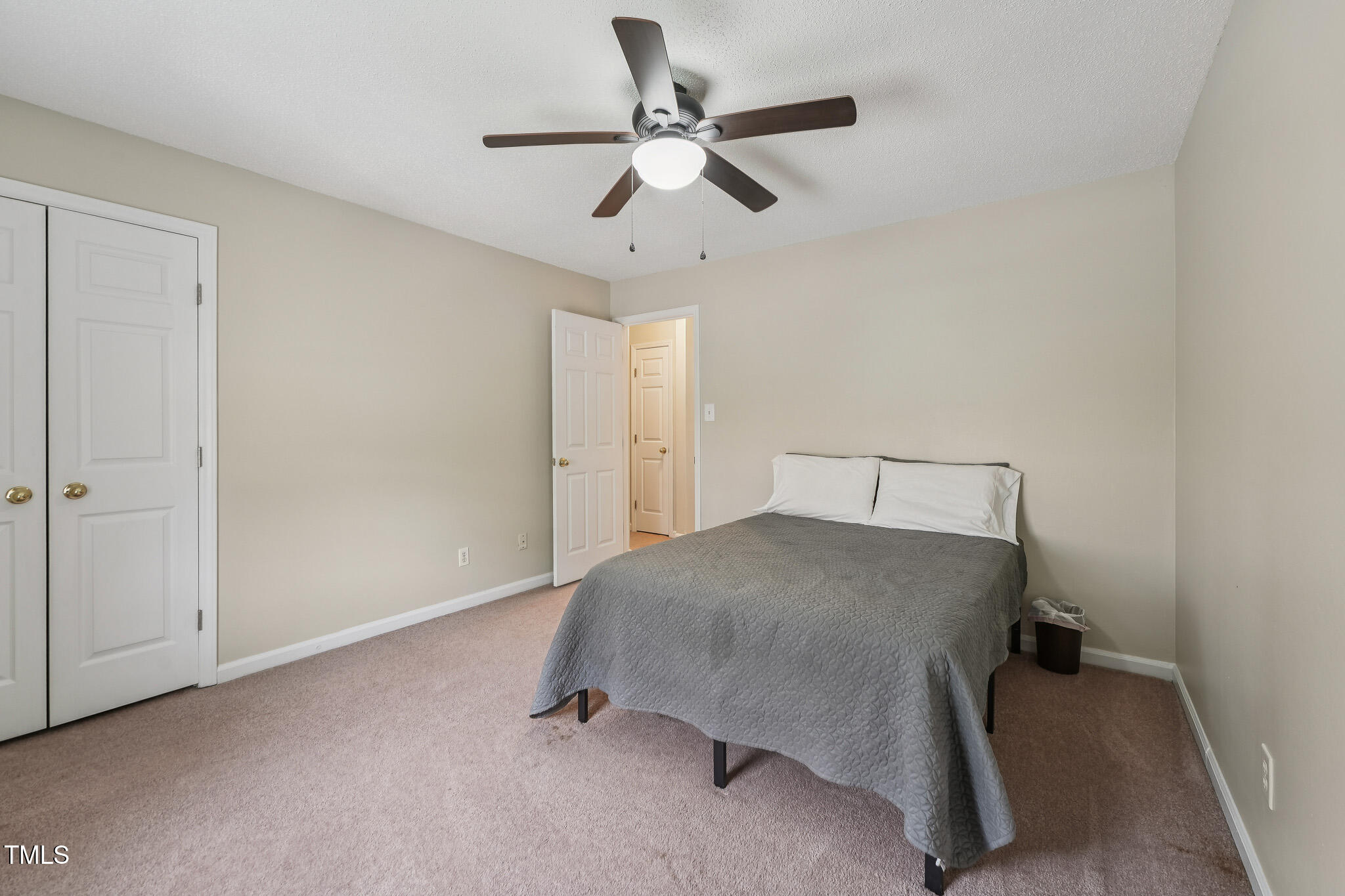 149 Jones Franklin Road, Unit A Raleigh, NC 27606 - Photo 13 of 21 a bedroom with a bed and a ceiling fan