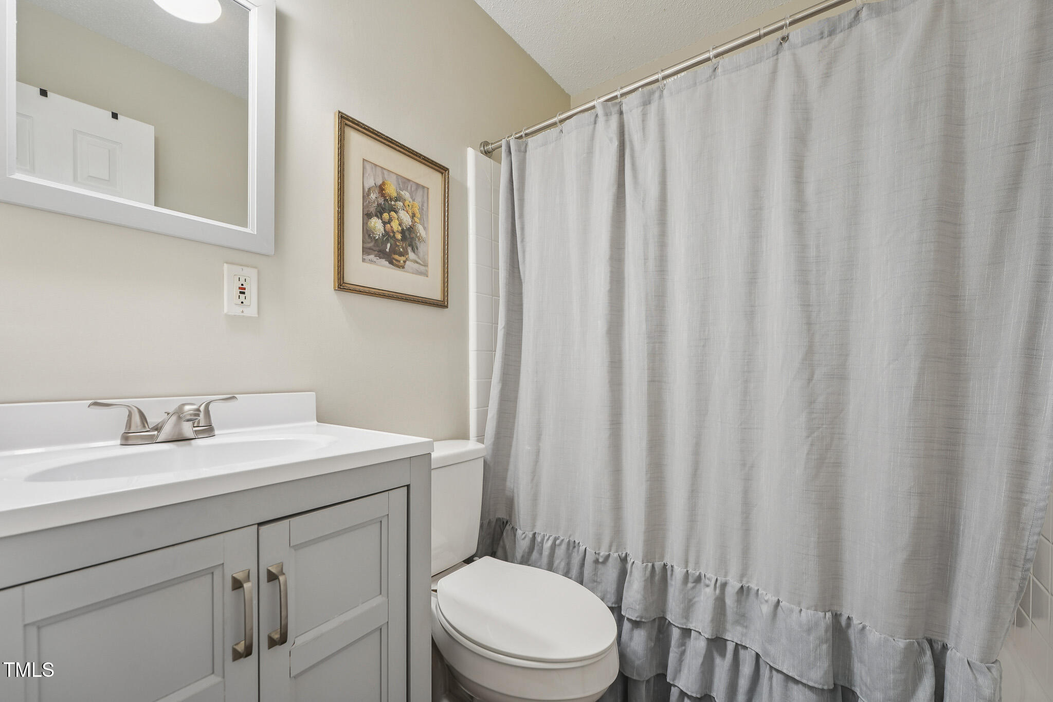 149 Jones Franklin Road, Unit A Raleigh, NC 27606 - Photo 14 of 21 a bathroom with a sink a toilet and a mirror
