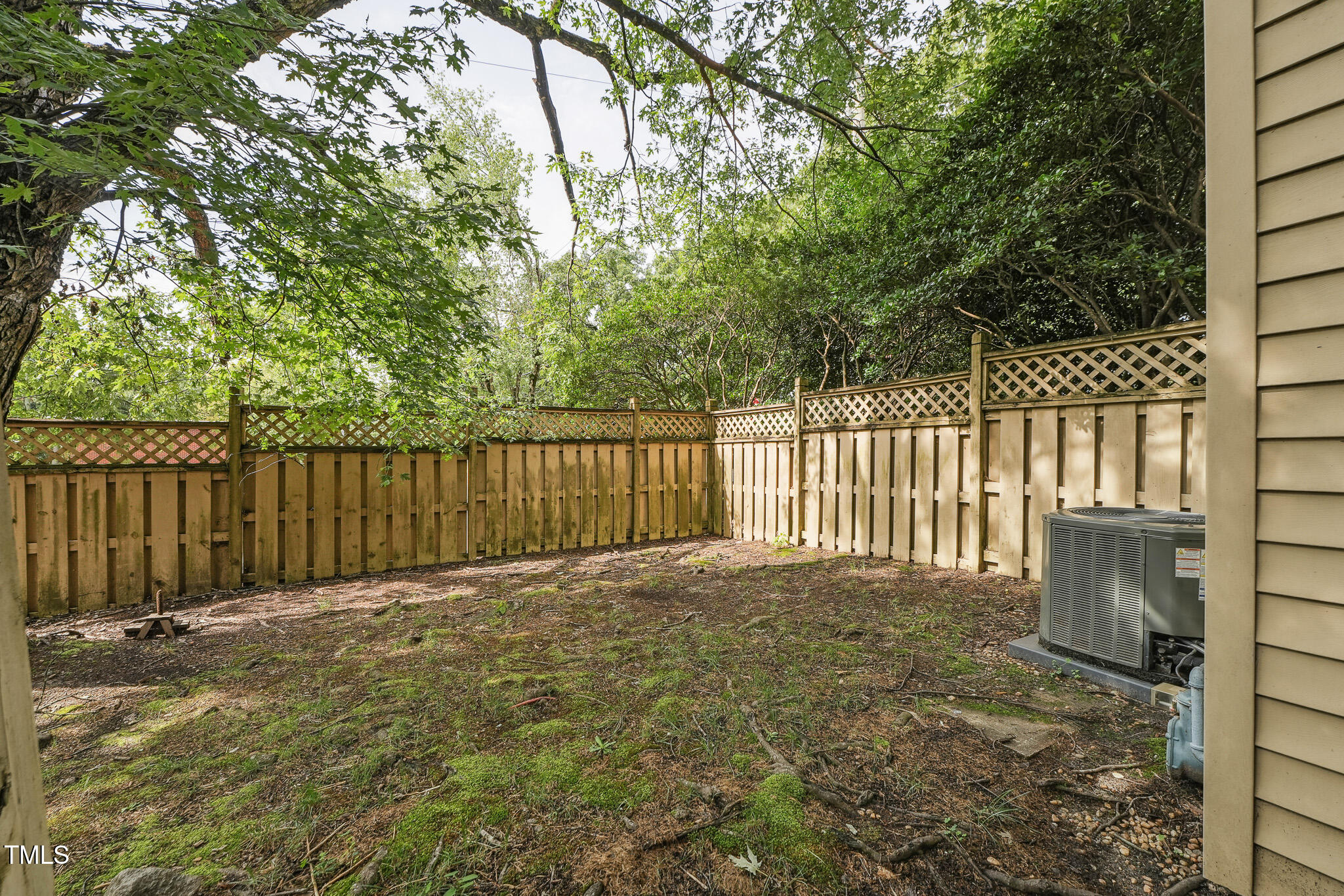 149 Jones Franklin Road, Unit A Raleigh, NC 27606 - Photo 15 of 21 a view of backyard with wooden fence and trees