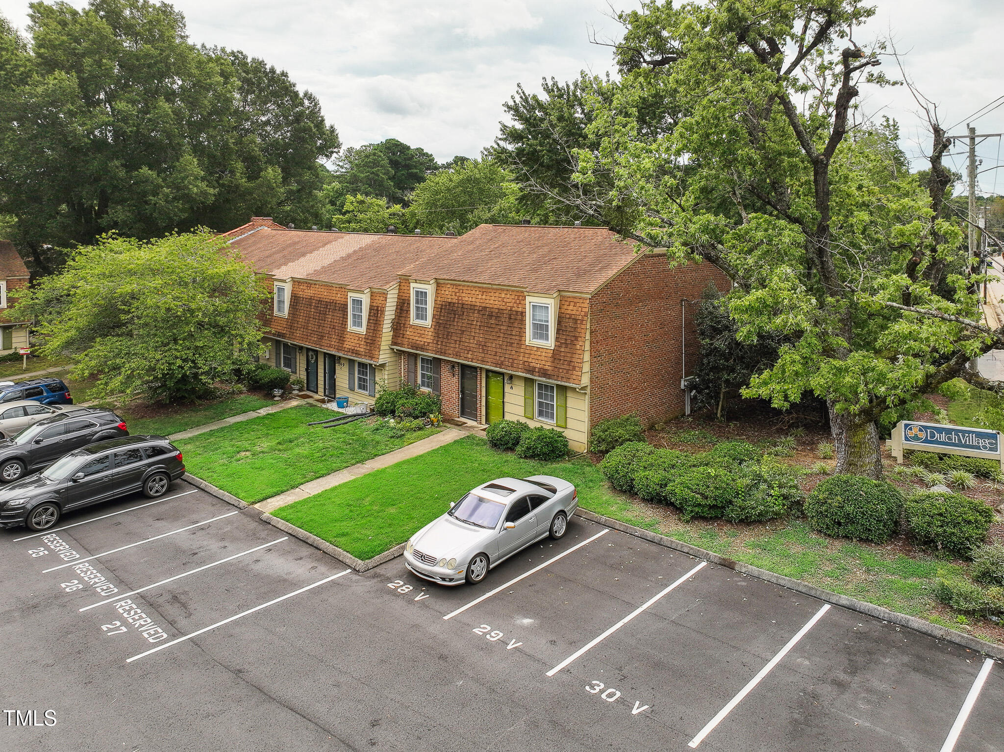149 Jones Franklin Road, Unit A Raleigh, NC 27606 - Photo 16 of 21 a car parked in front of a house and a yard